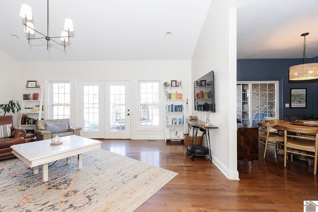 living room with a notable chandelier and dark wood-type flooring