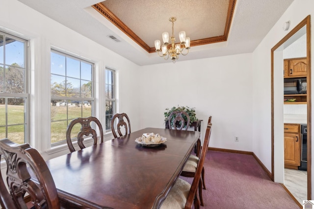 dining area with a notable chandelier, a raised ceiling, a textured ceiling, and carpet