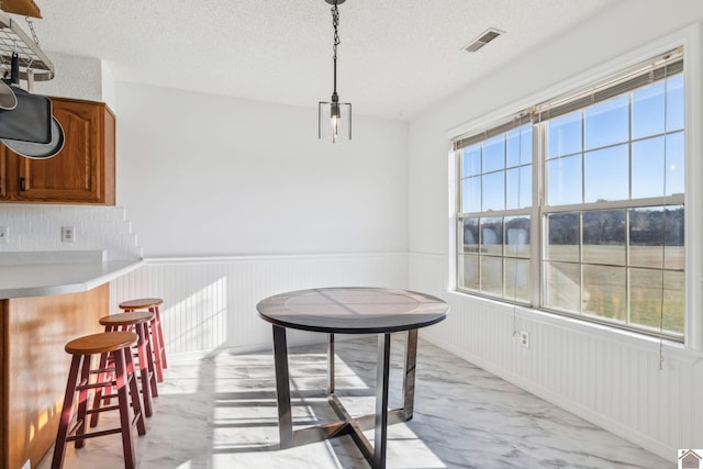 dining area with a textured ceiling