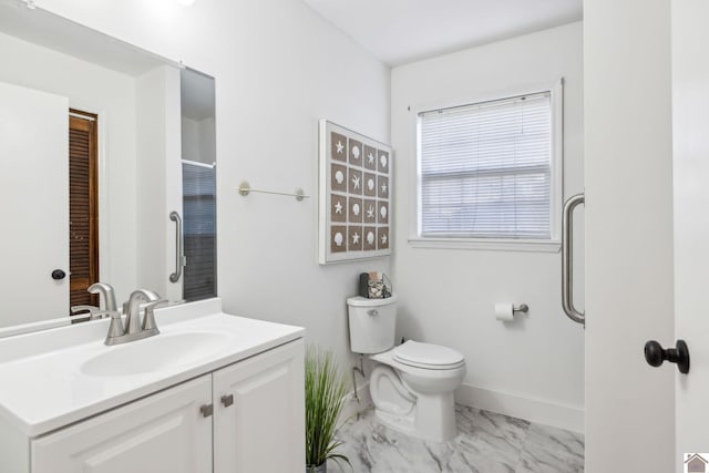 bathroom with vanity, a shower, and toilet