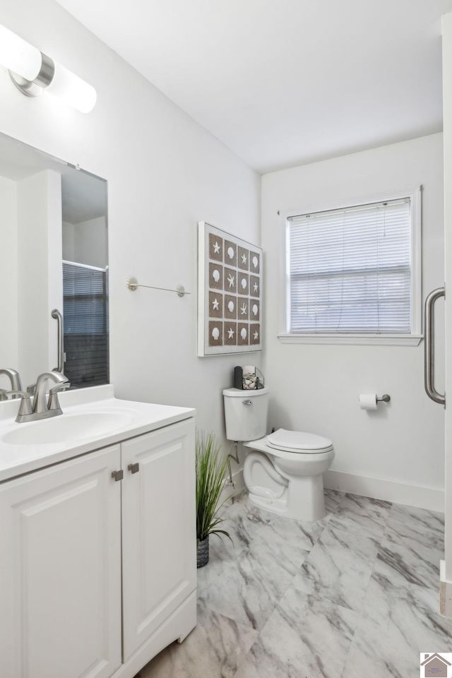 bathroom with vanity, an enclosed shower, and toilet