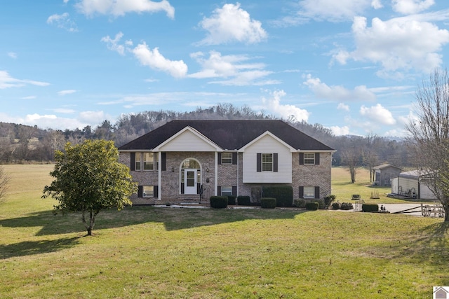 raised ranch featuring a front lawn