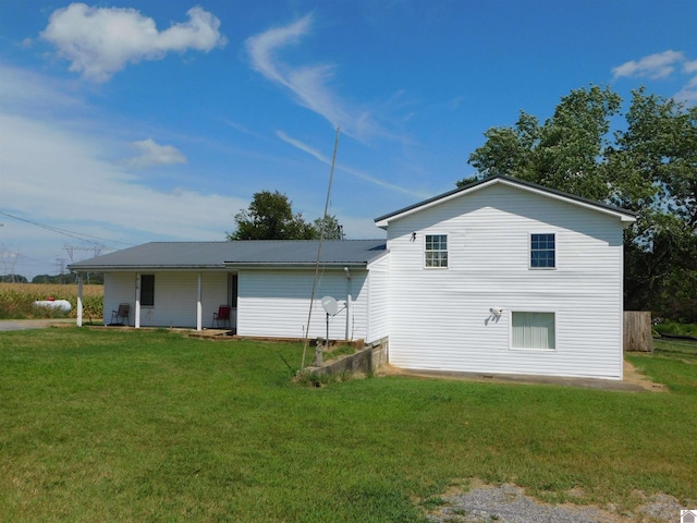 rear view of property with a lawn