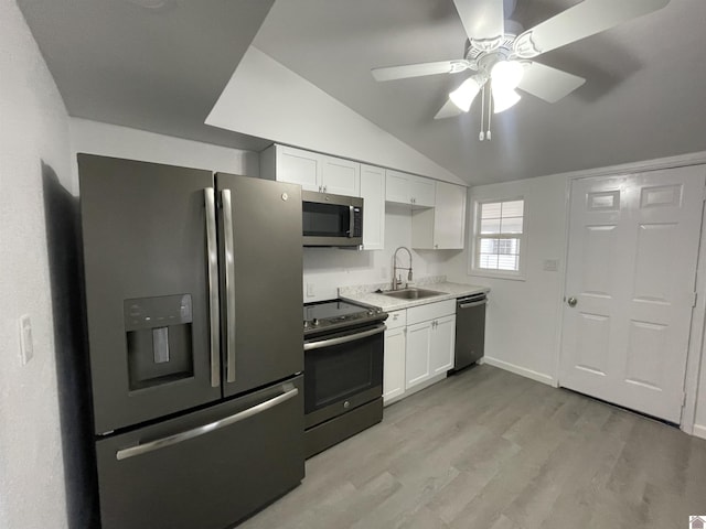 kitchen with white cabinetry, lofted ceiling, sink, light hardwood / wood-style floors, and stainless steel appliances