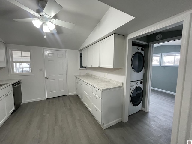 laundry room featuring light hardwood / wood-style flooring, ceiling fan, and stacked washing maching and dryer