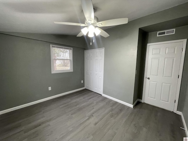 unfurnished bedroom with ceiling fan, wood-type flooring, vaulted ceiling, and a closet