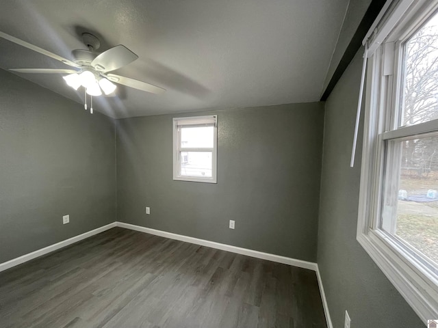 unfurnished room with dark wood-type flooring and ceiling fan