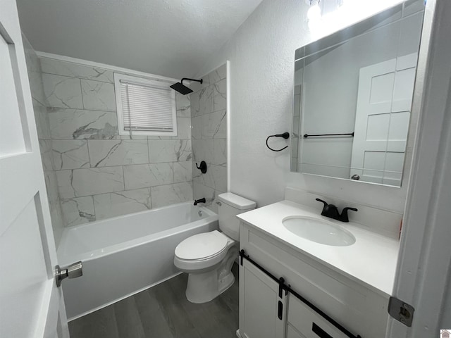 full bathroom with hardwood / wood-style flooring, vanity, toilet, and tiled shower / bath