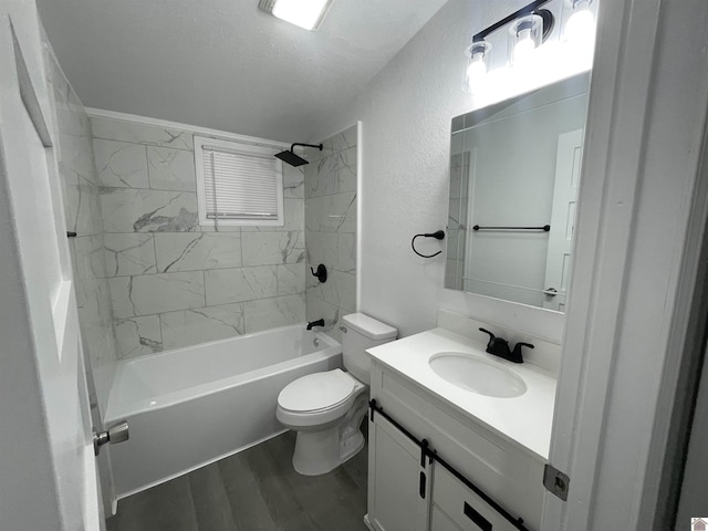 full bathroom featuring hardwood / wood-style flooring, vanity, a textured ceiling, tiled shower / bath, and toilet