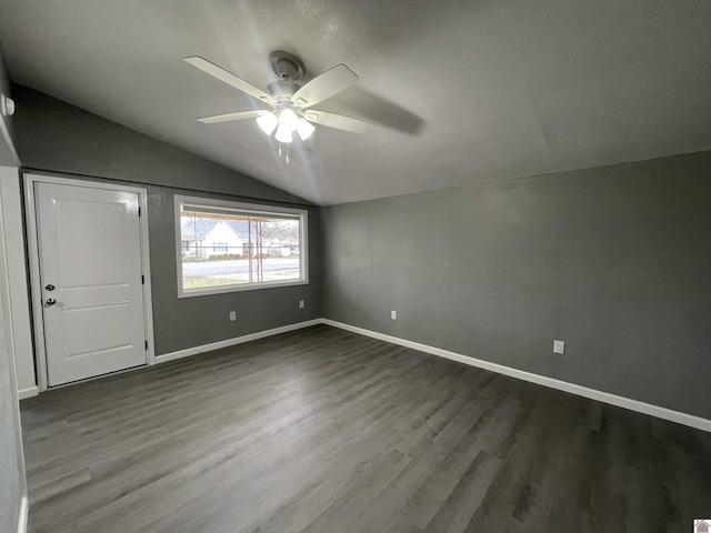 unfurnished bedroom with lofted ceiling, dark hardwood / wood-style floors, and ceiling fan