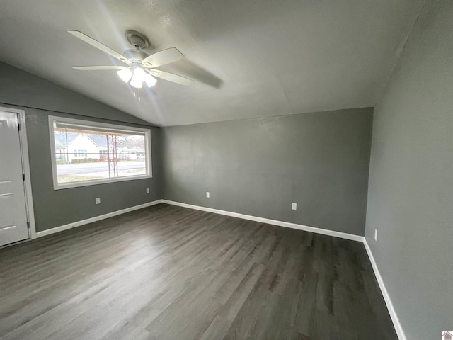 interior space featuring ceiling fan, dark hardwood / wood-style flooring, and vaulted ceiling