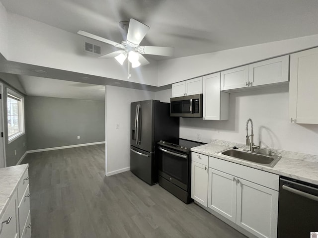 kitchen featuring white cabinetry, sink, light hardwood / wood-style flooring, and stainless steel appliances