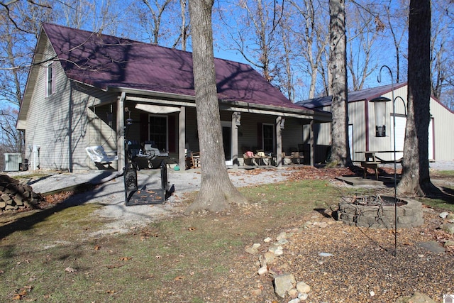 back of house featuring central AC unit and covered porch