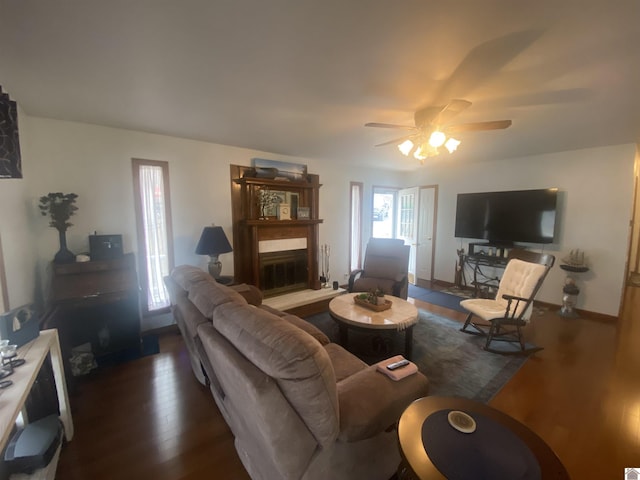 living room featuring dark hardwood / wood-style floors and ceiling fan