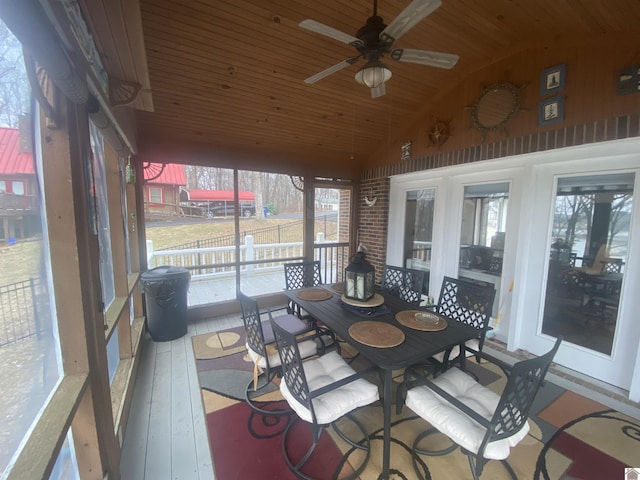 sunroom featuring ceiling fan, lofted ceiling, and wood ceiling