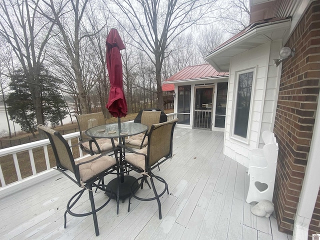 wooden deck featuring a sunroom