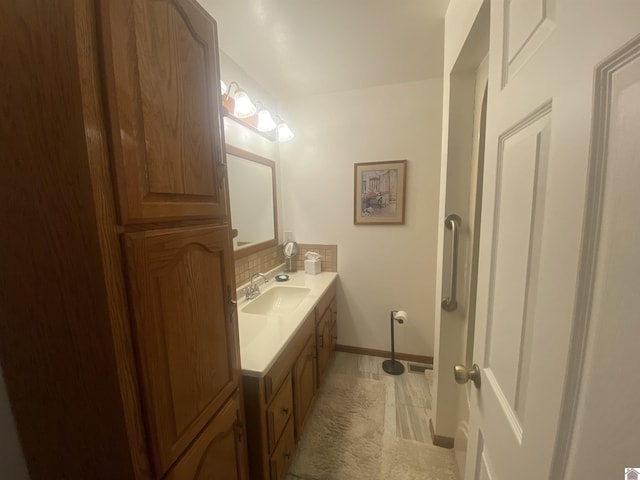 bathroom featuring tasteful backsplash and vanity