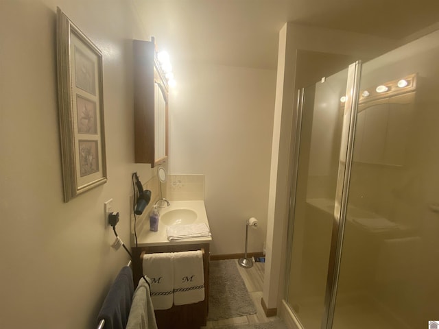 bathroom with walk in shower and vanity