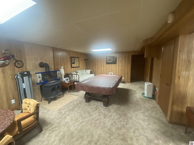 recreation room with pool table, carpet flooring, a wood stove, and wooden walls