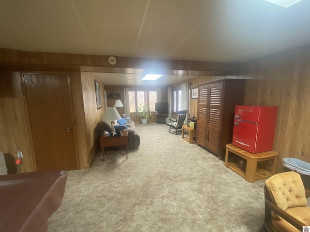 interior space with light carpet and wooden walls