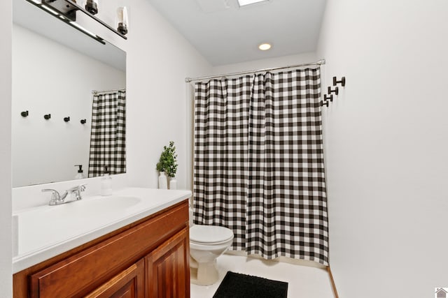 bathroom with tile patterned flooring, vanity, and toilet