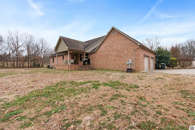 view of home's exterior featuring a garage and a porch