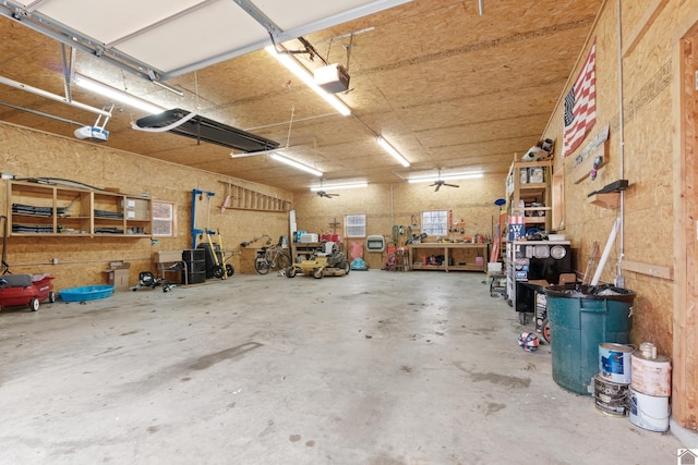 garage featuring a garage door opener and a workshop area