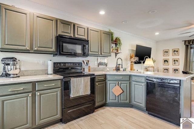 kitchen featuring sink, crown molding, light hardwood / wood-style floors, black appliances, and kitchen peninsula