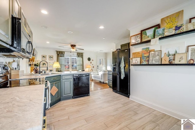 kitchen featuring black appliances, sink, ornamental molding, kitchen peninsula, and light wood-type flooring