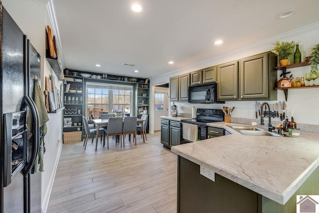 kitchen featuring sink, black appliances, kitchen peninsula, and light wood-type flooring