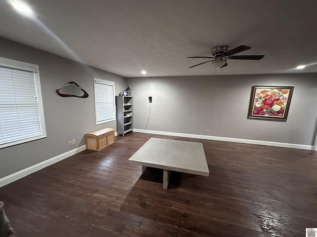 unfurnished living room with dark wood-type flooring and ceiling fan