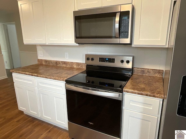 kitchen featuring stainless steel appliances, white cabinetry, and wood-type flooring