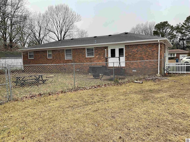 rear view of house featuring a yard