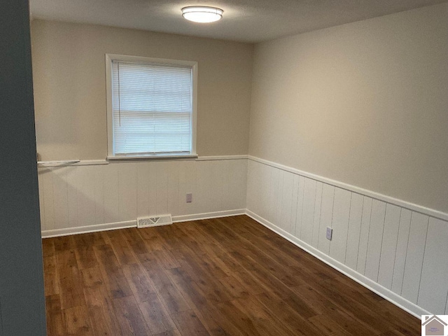 spare room with dark wood-type flooring