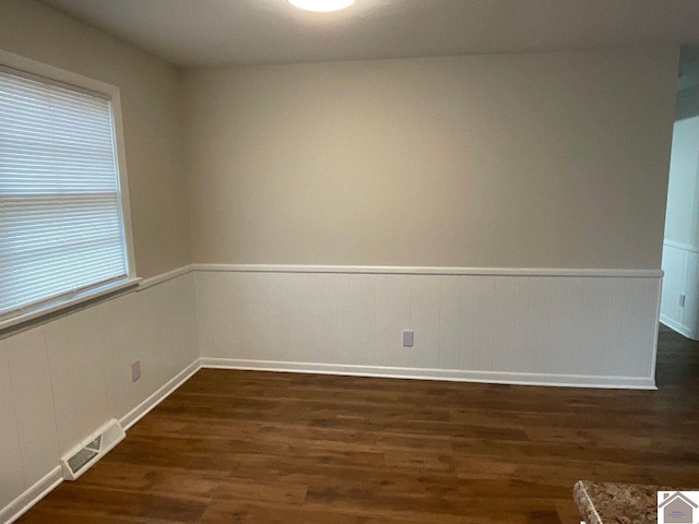 empty room with dark hardwood / wood-style flooring