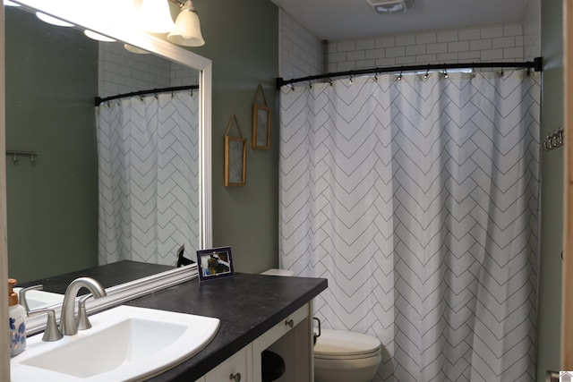 bathroom with vanity, toilet, and walk in shower