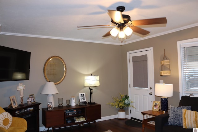 living room with dark wood-type flooring, ornamental molding, and ceiling fan