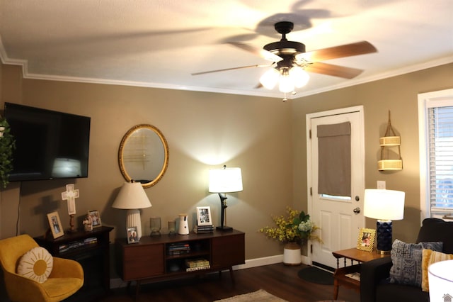 sitting room featuring dark wood-type flooring, ceiling fan, and ornamental molding