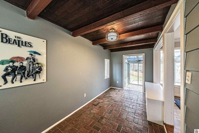 doorway featuring wooden ceiling and beamed ceiling