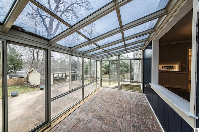 unfurnished sunroom with a skylight