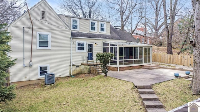 back of house with a patio, a sunroom, a lawn, and central air condition unit