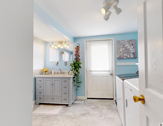 bathroom featuring vanity and separate washer and dryer