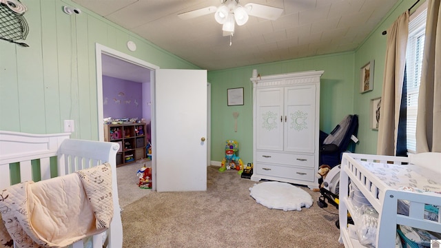 carpeted bedroom featuring ornamental molding and ceiling fan