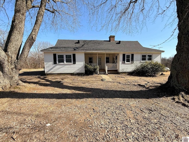 rear view of property featuring a porch