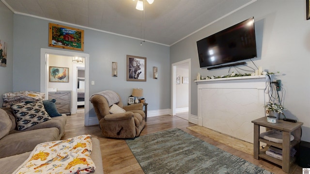 living room with hardwood / wood-style flooring and ornamental molding