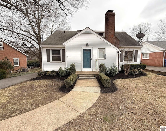 bungalow-style house with central air condition unit