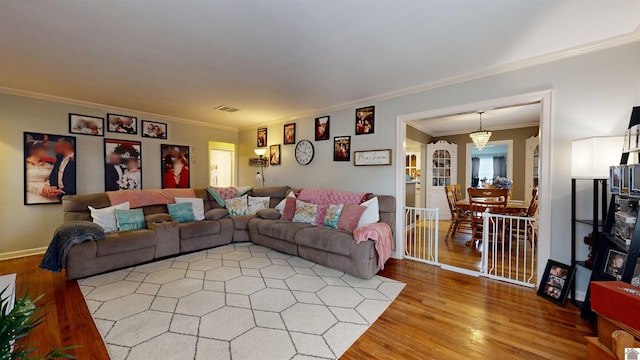 living room with ornamental molding and hardwood / wood-style floors