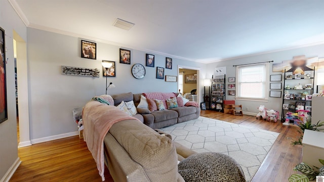 living room with crown molding and hardwood / wood-style floors