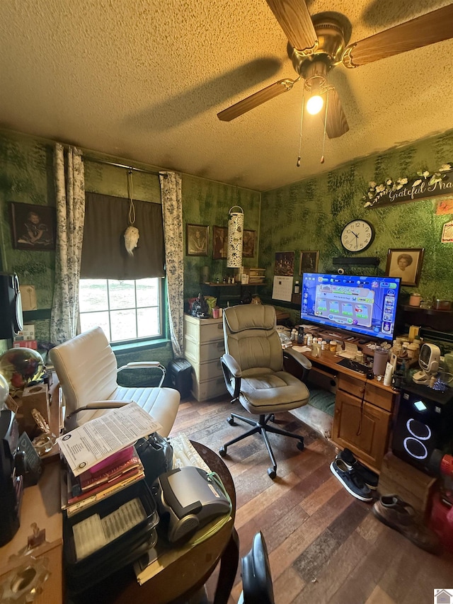 living room featuring ceiling fan, hardwood / wood-style flooring, and a textured ceiling