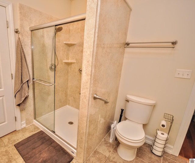 bathroom featuring an enclosed shower, tile patterned floors, and toilet